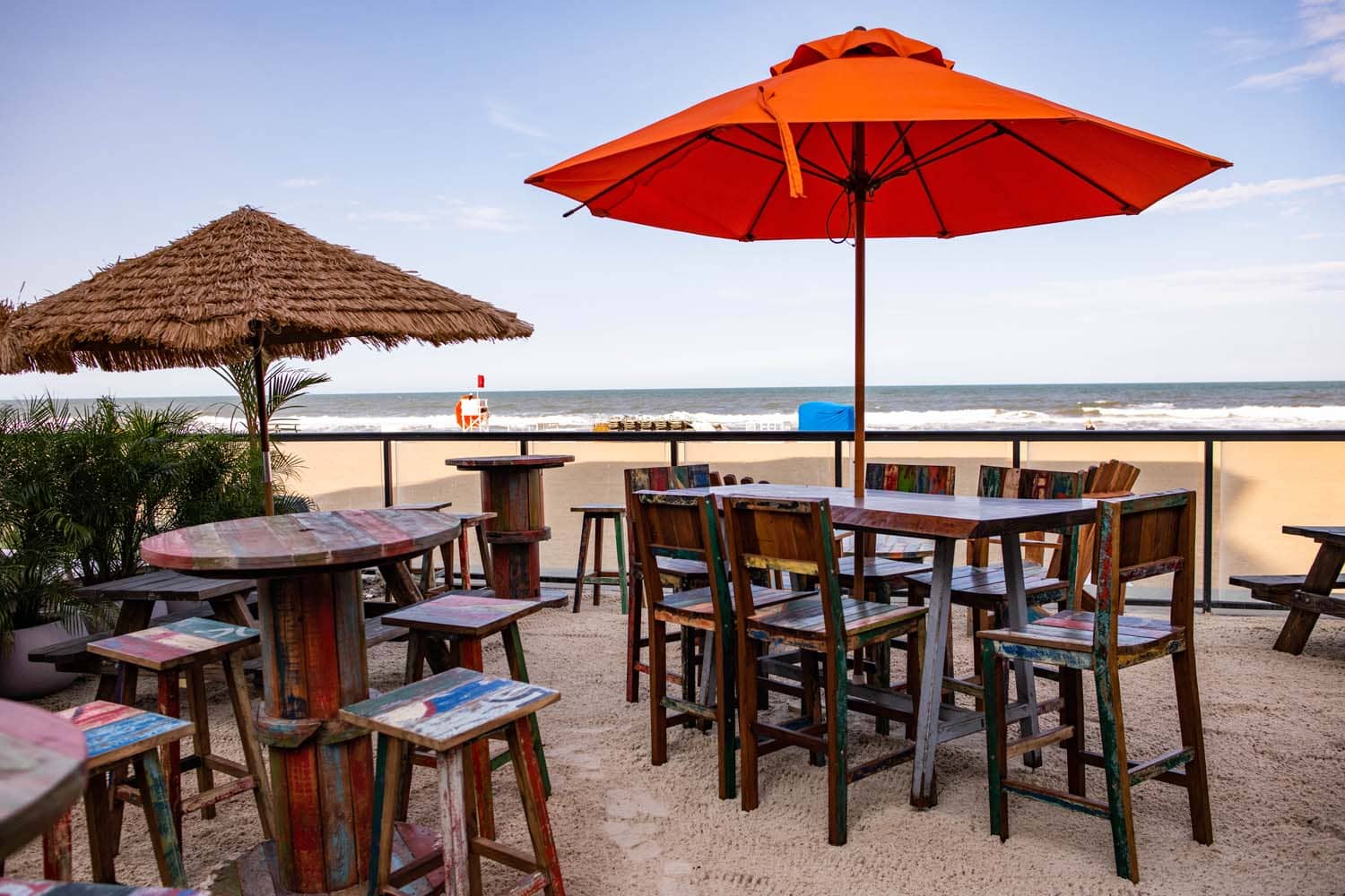 Outdoor tables and chairs at a seaside restaurant