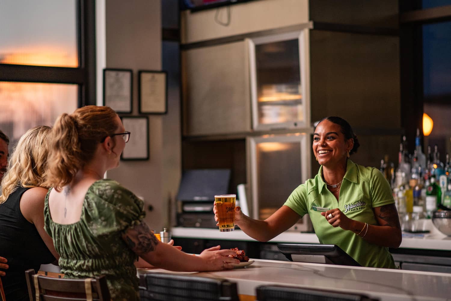 A bartender serving drinks at Arbuckle's Bar & Grill