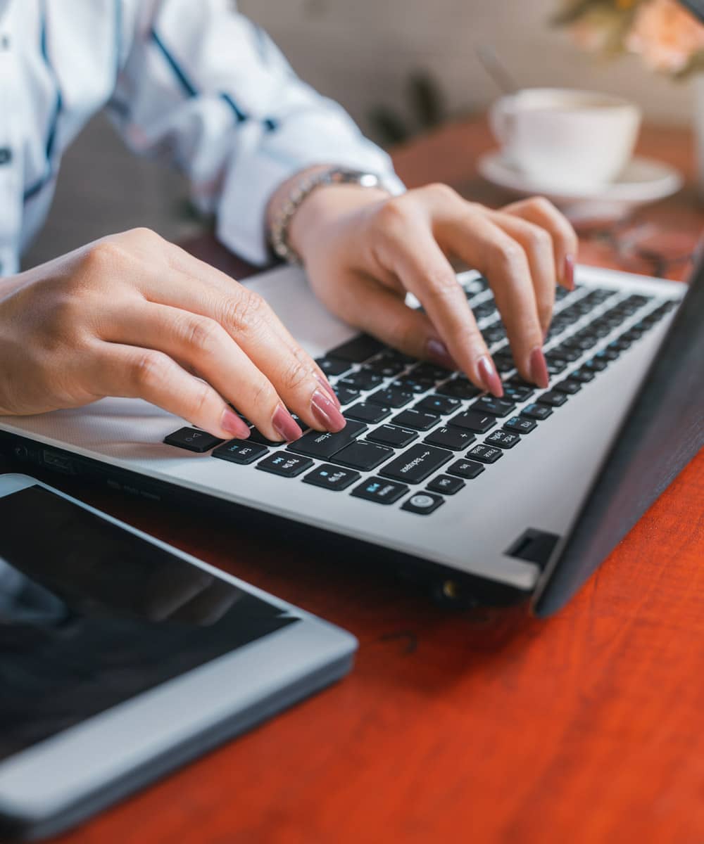 Woman typing on a laptop