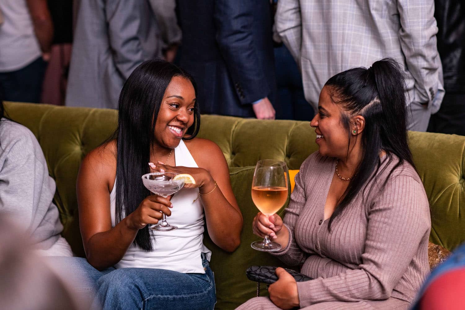 Two women sitting inside The Raleigh Room with drinks