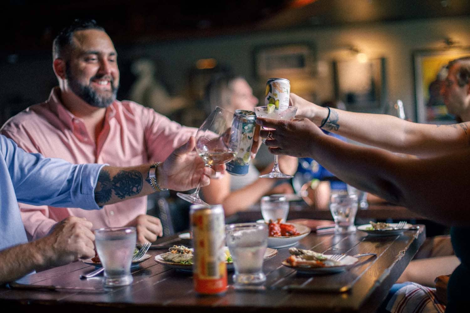 A group of friends toasting drinks at the Hunt Room restaurant