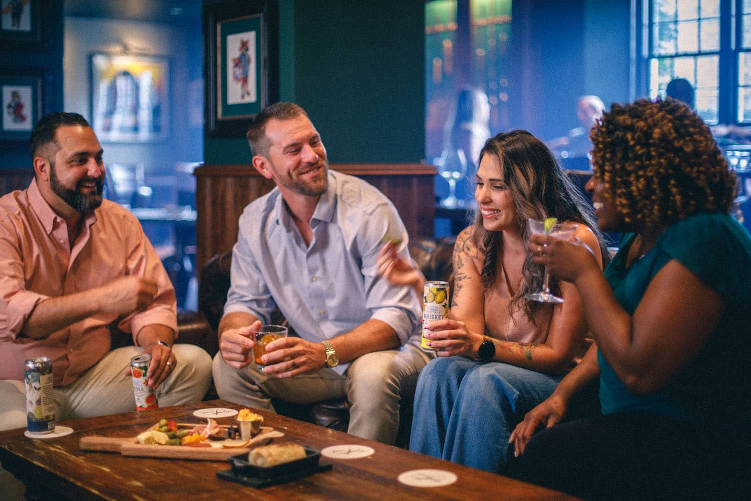 A group of people laughing at happy hour at the Hunt Room