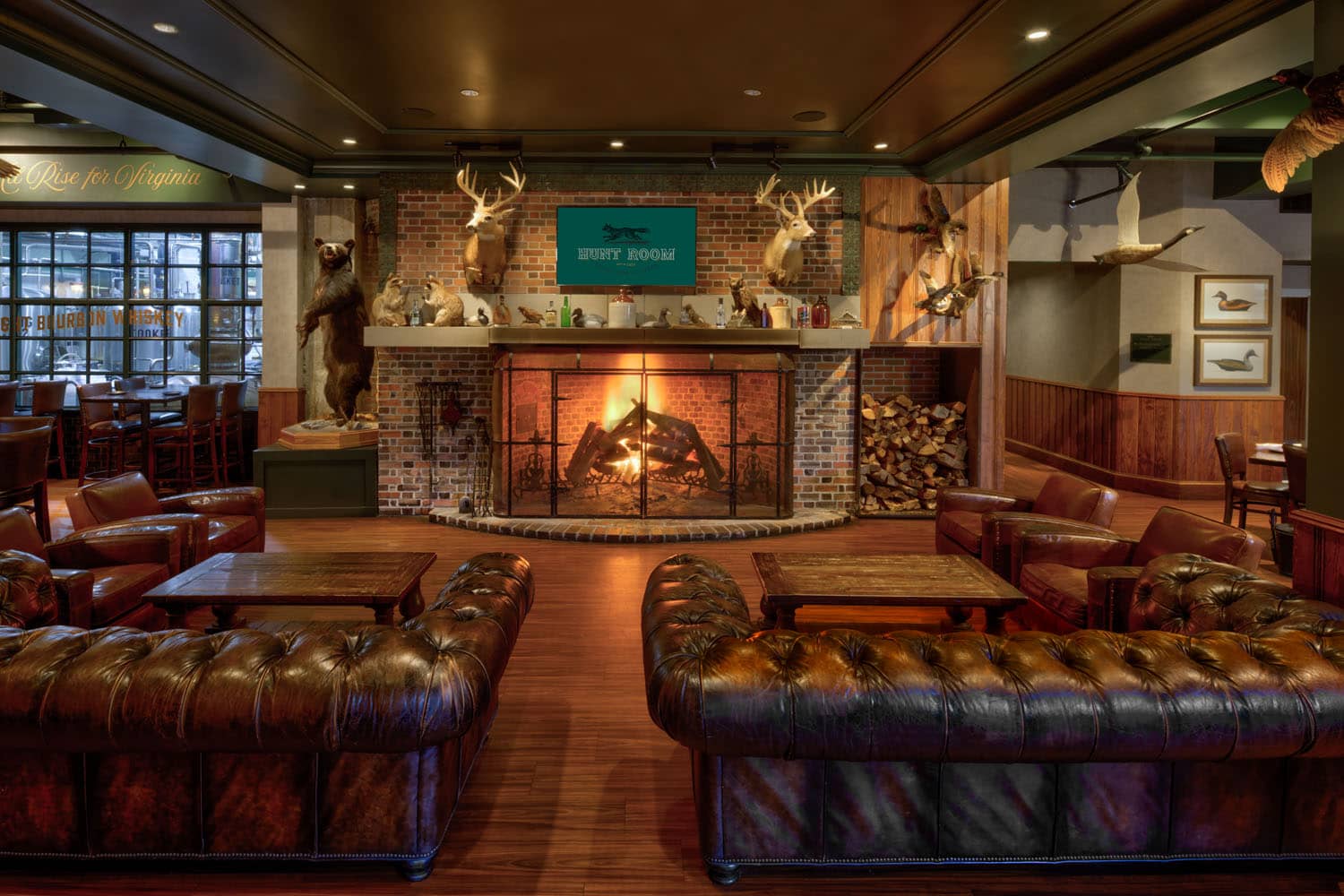 The interior dining room at the Hunt Room restaurant with a fireplace