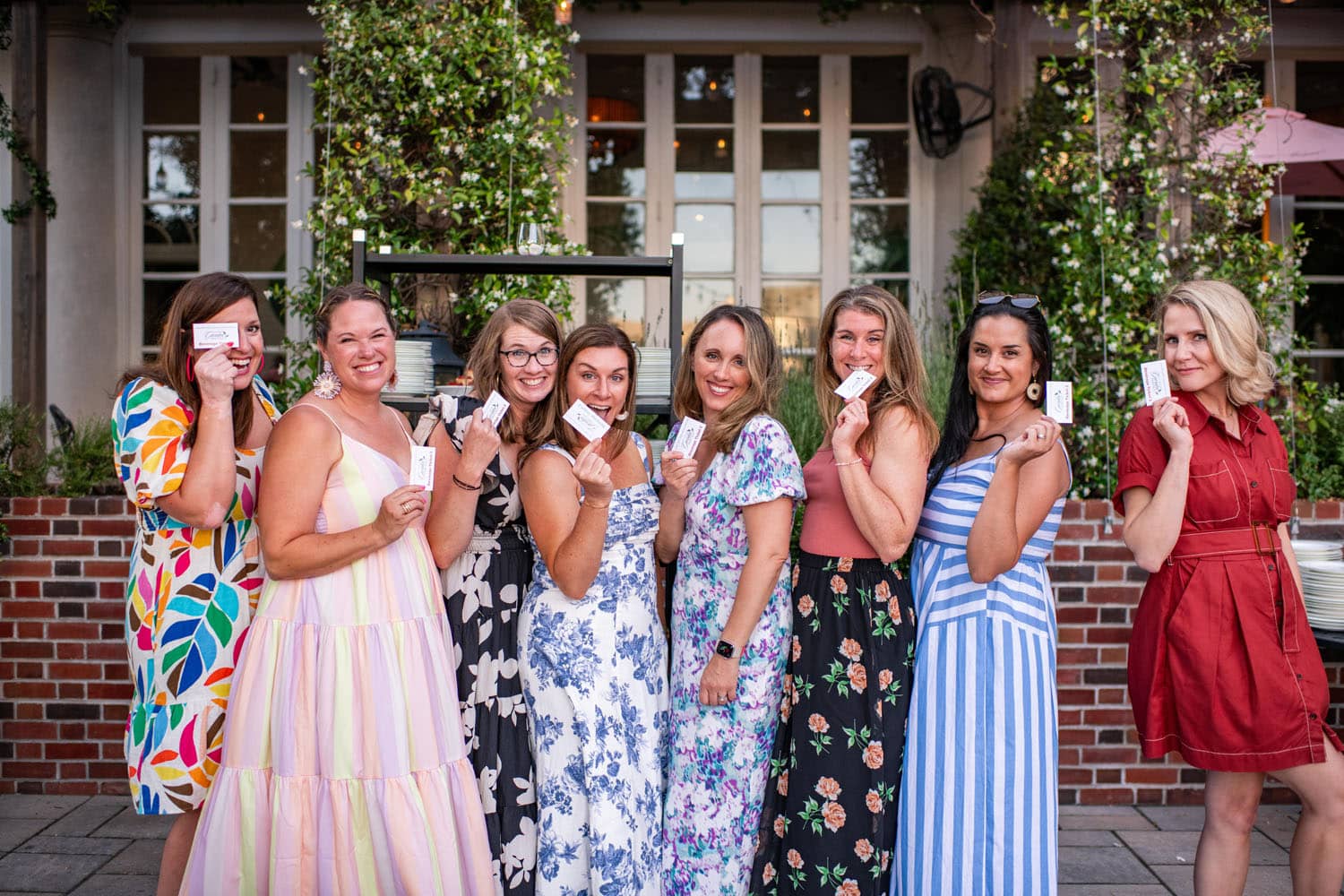 A group of women attending an outdoor party inside a garden