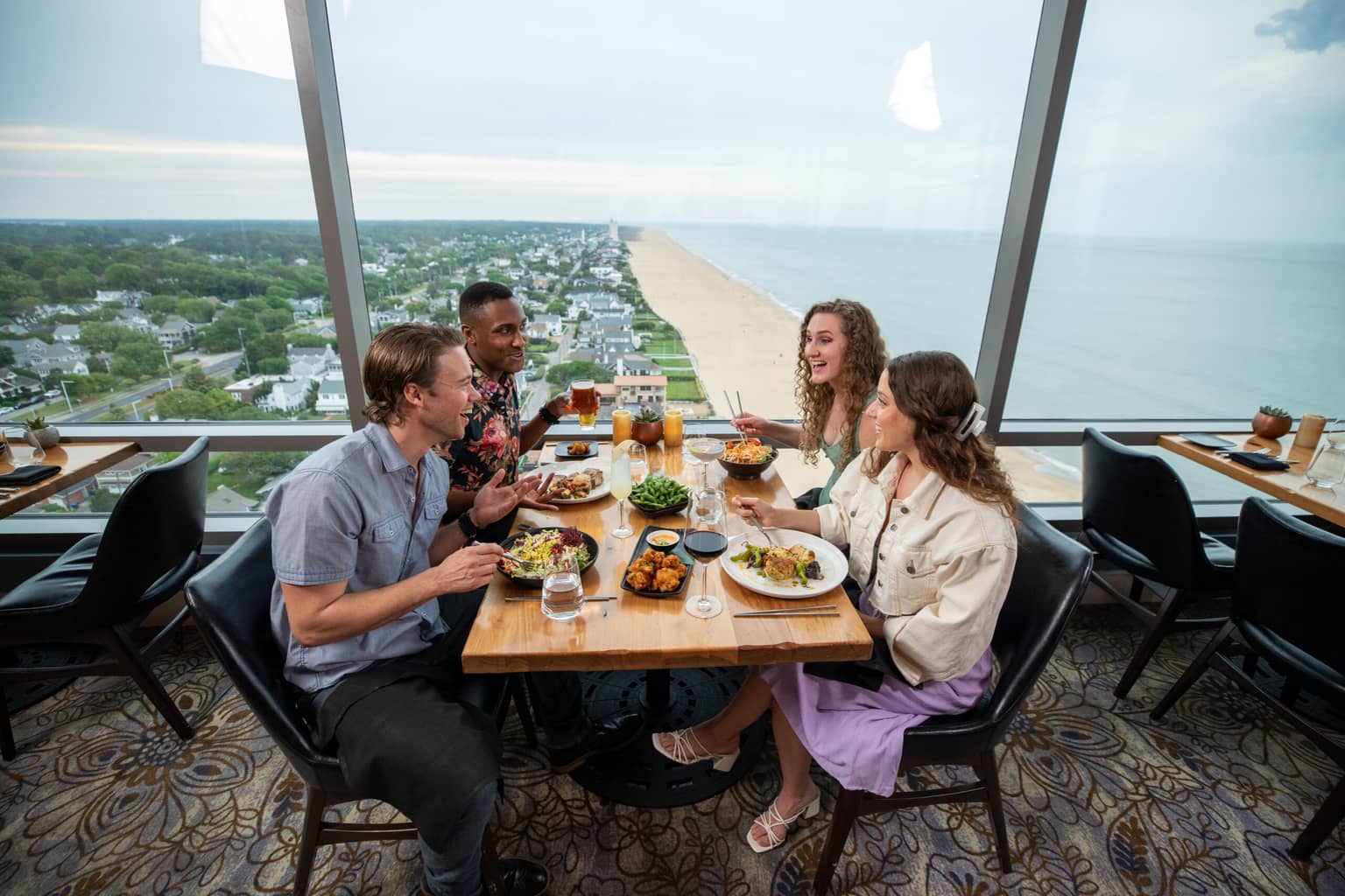 A group of four people eating dinner at Orion's Roof