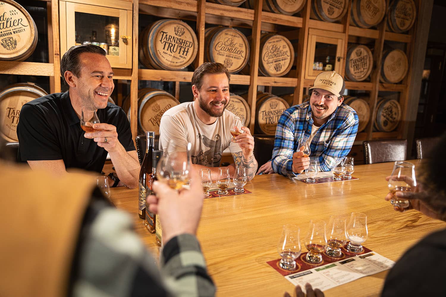 A group of men enjoying a bourbon tasting at Tarnished Truth Distillery