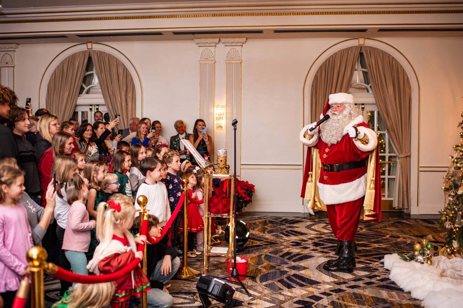 Santa singing to a large group of children