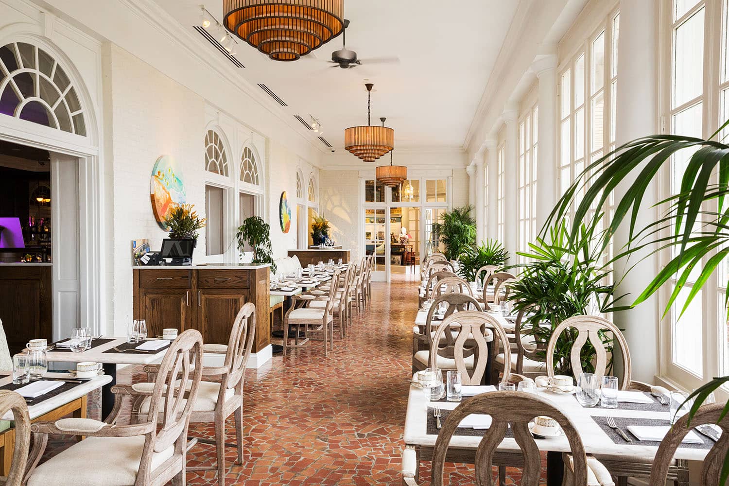 The sunroom dining area inside Becca Restaurant & Garden at The Cavalier Hotel