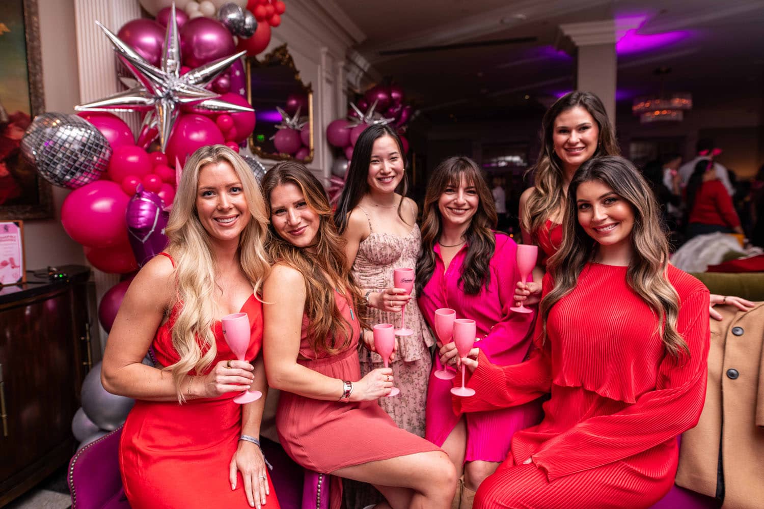 A group of women celebrating with drinks at a special event inside The Historic Cavalier Hotel