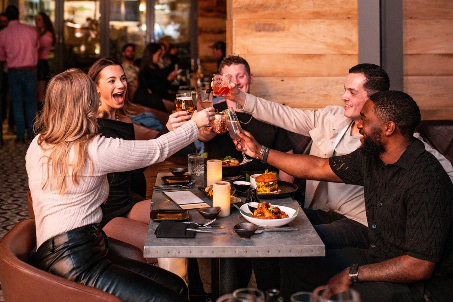 A group of friends enjoying drinks at Orion's Roof