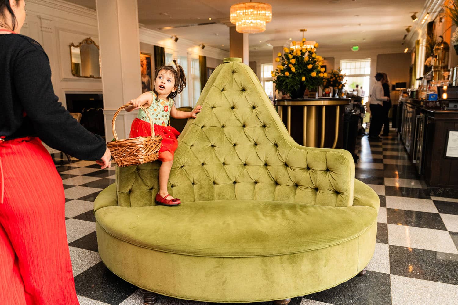 A child on a chair holding an Easter Egg basket