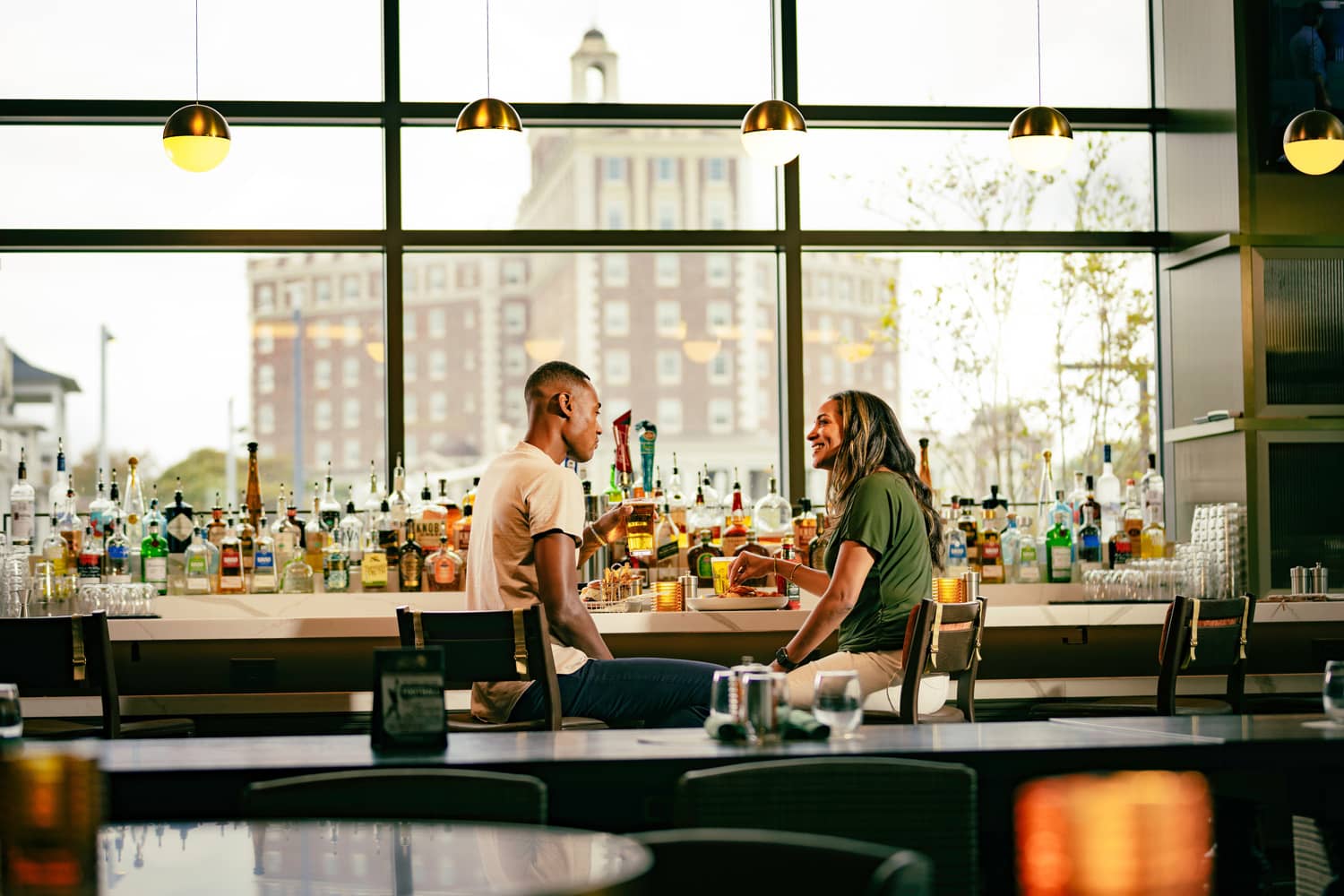 A couple sharing a meal at the bar inside Arbuckle's Bar & Grill