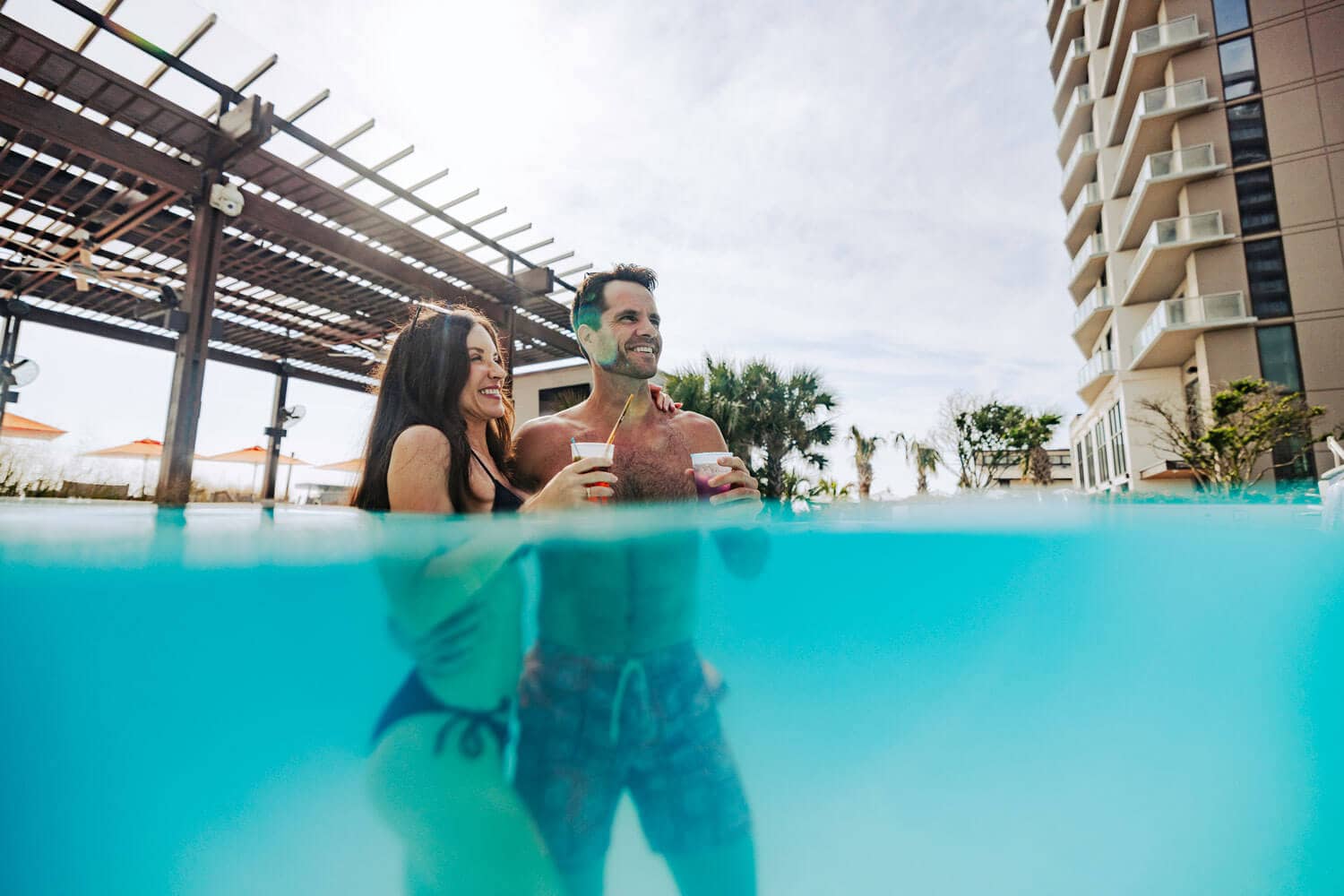 A couple swimming the Cavalier Beach Club outdoor infinity pool