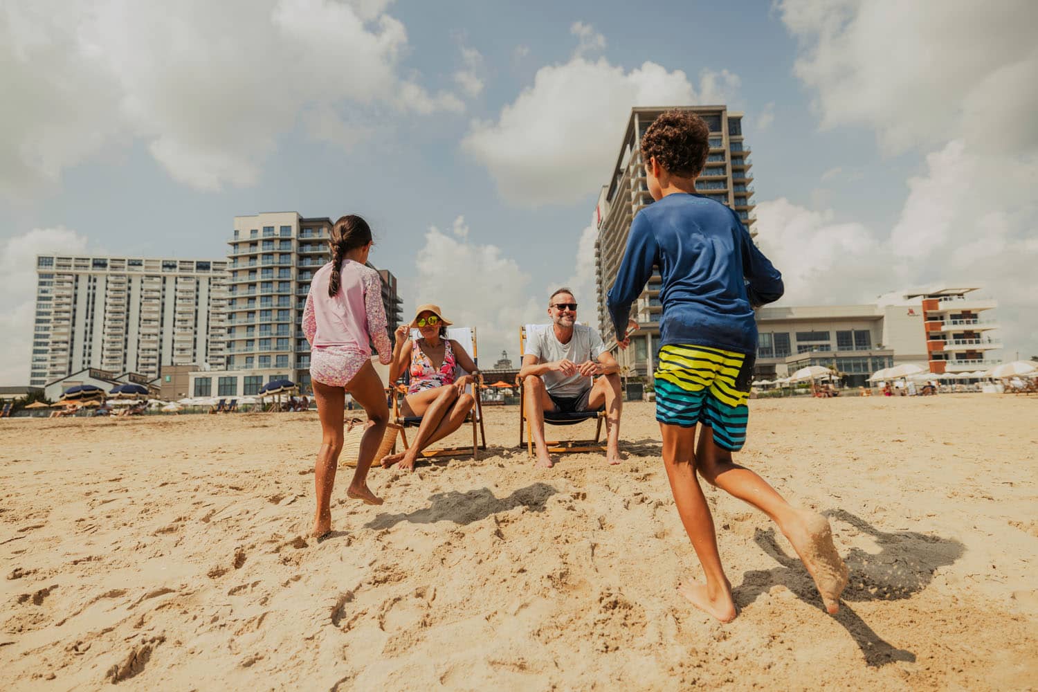 A family playing on the beach at the Cavalier Resort