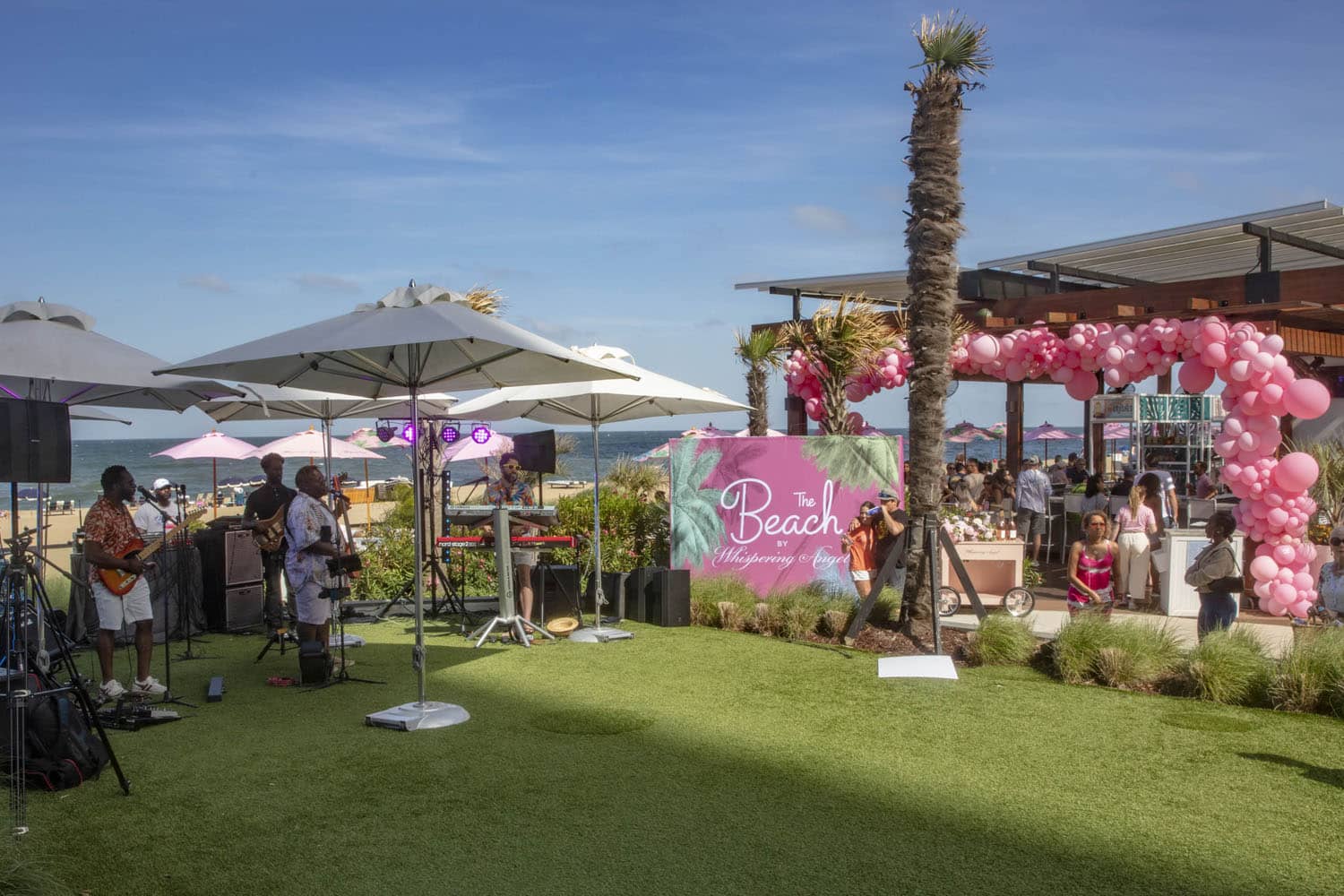 A live band playing music at an outdoor beach party