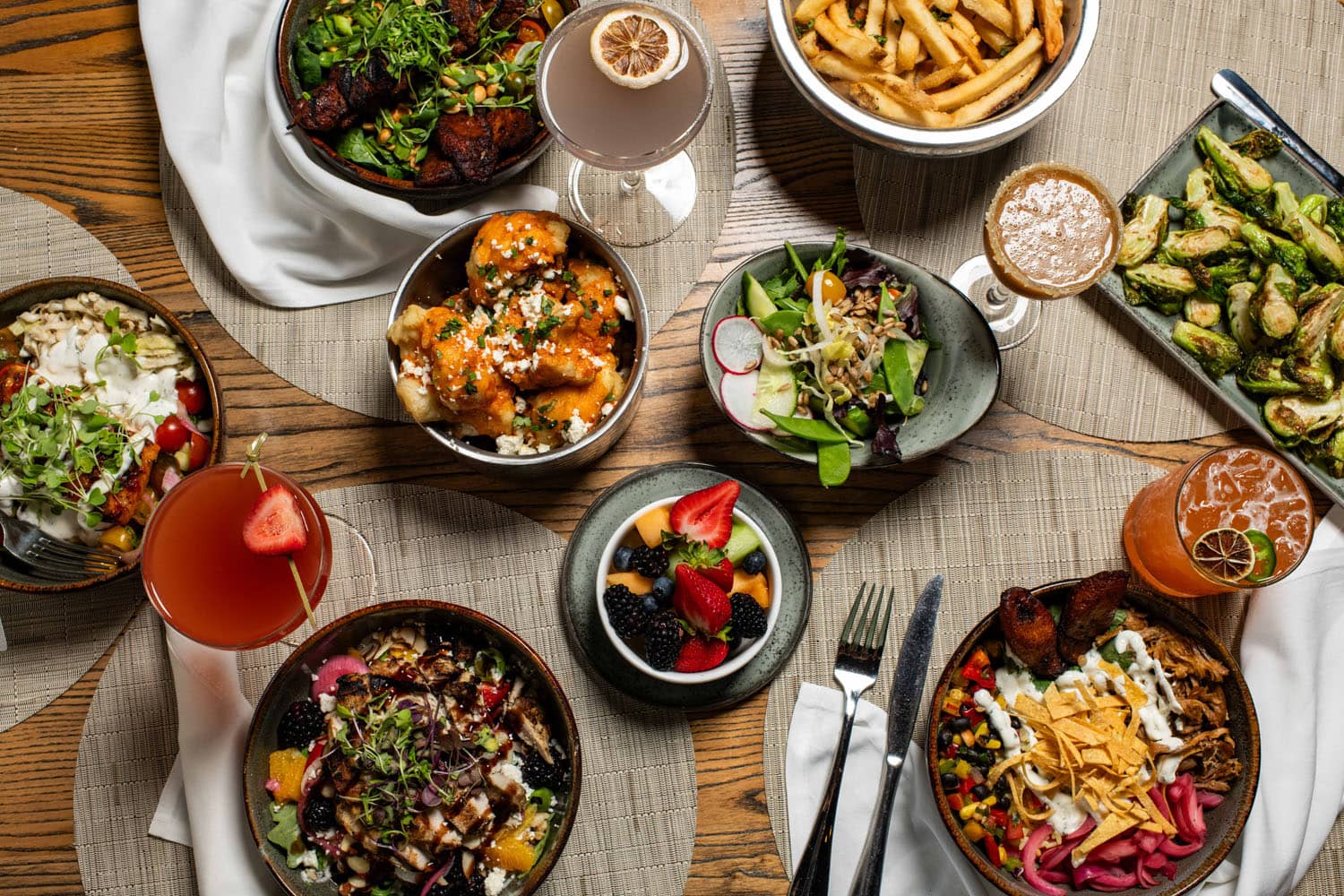 A sample of plated dishes on a table inside Tulu Seaside Bar & Grill