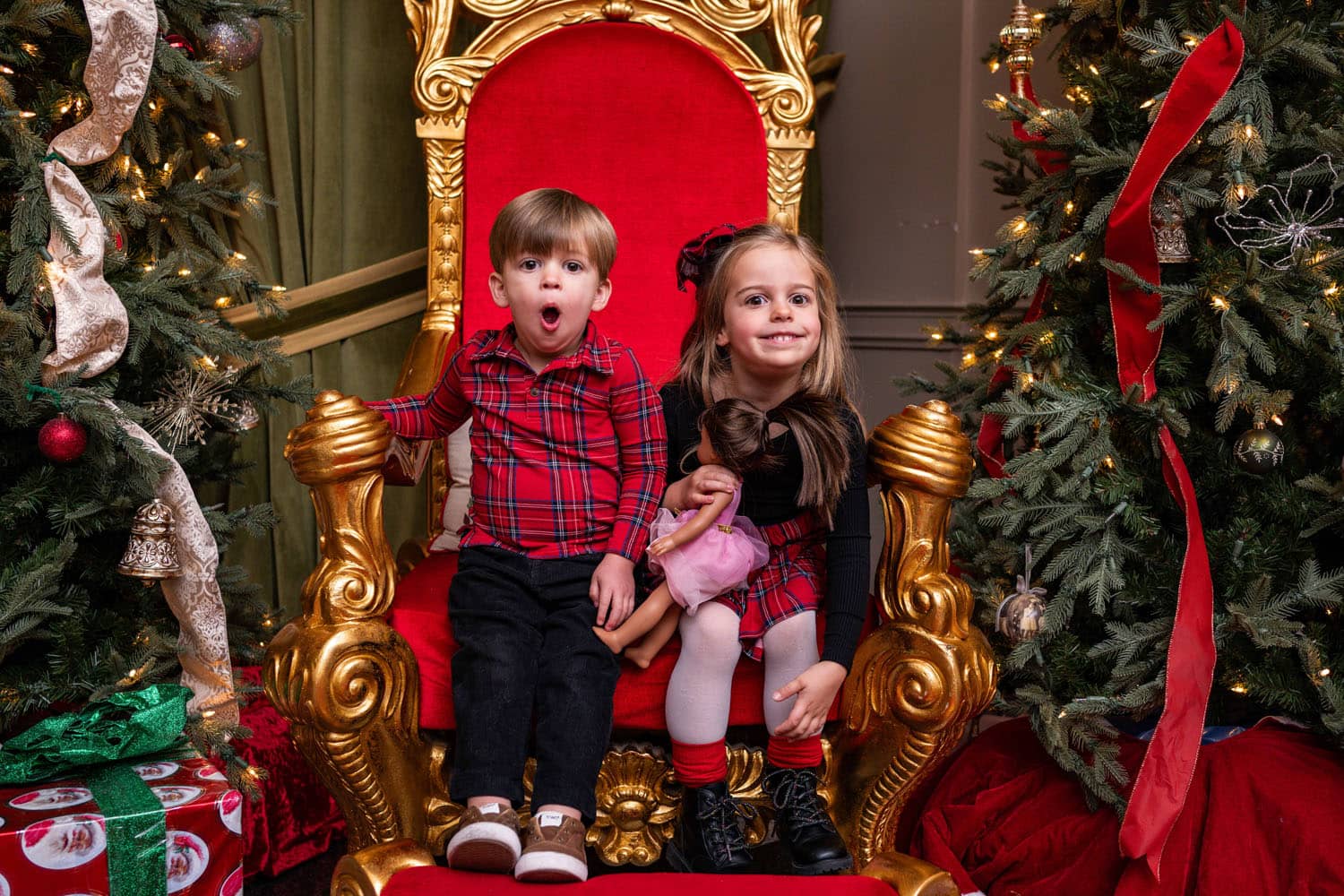 Two siblings waiting for Santa in a chair