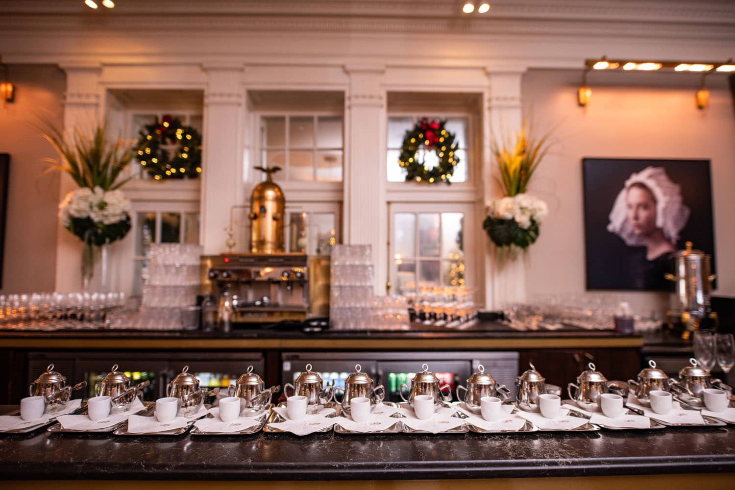 A dozen empty tea cups on the bar at The Raleigh Room