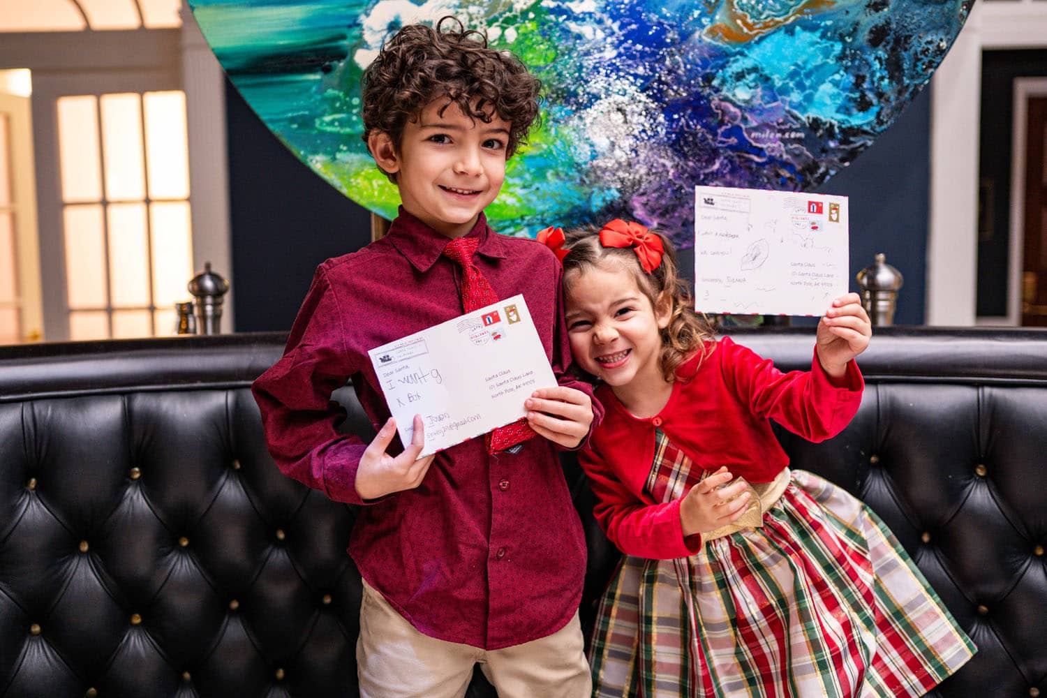 Two children writing letters to Santa