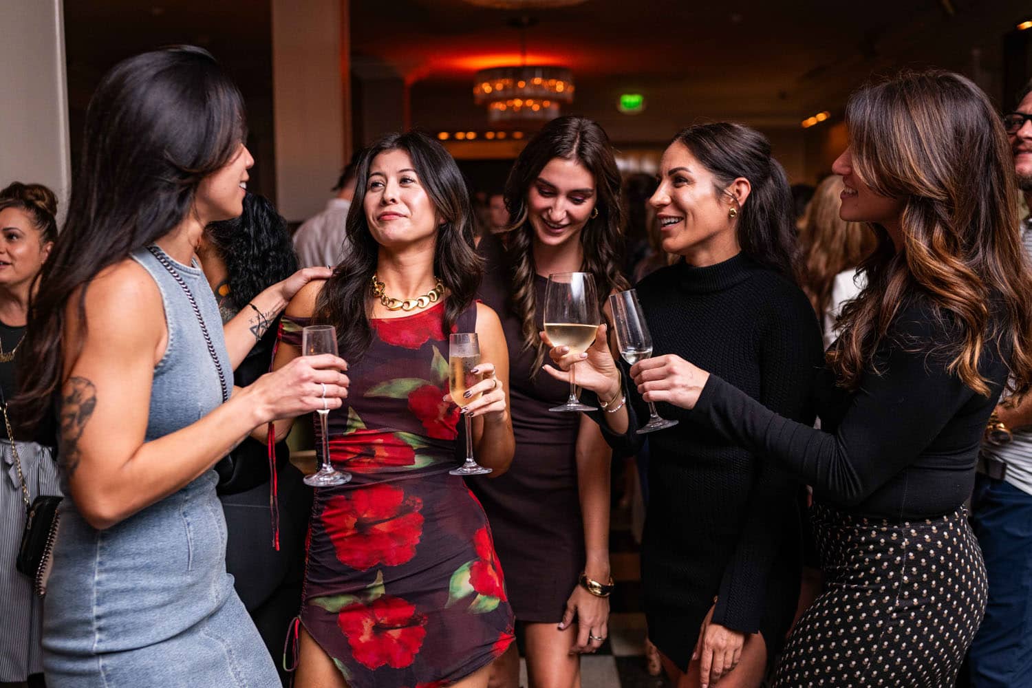 A group of ladies drinking champagne inside The Raleigh Room at The Historic Cavalier Hotel