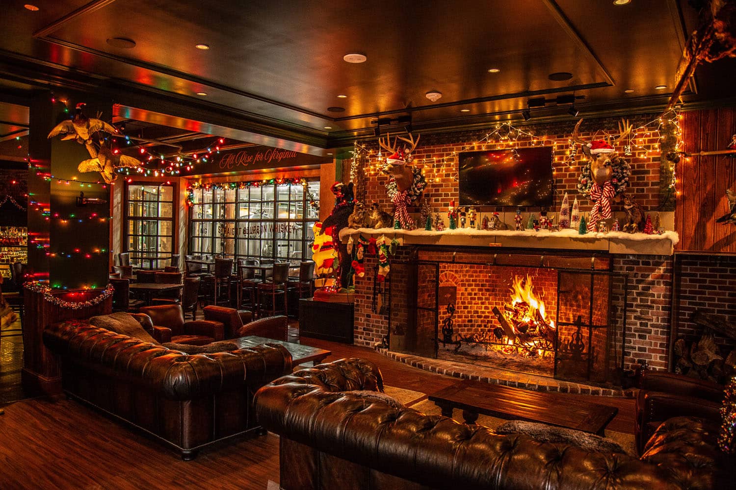 A roaring fireplace decorated for the holidays at the Hunt Room