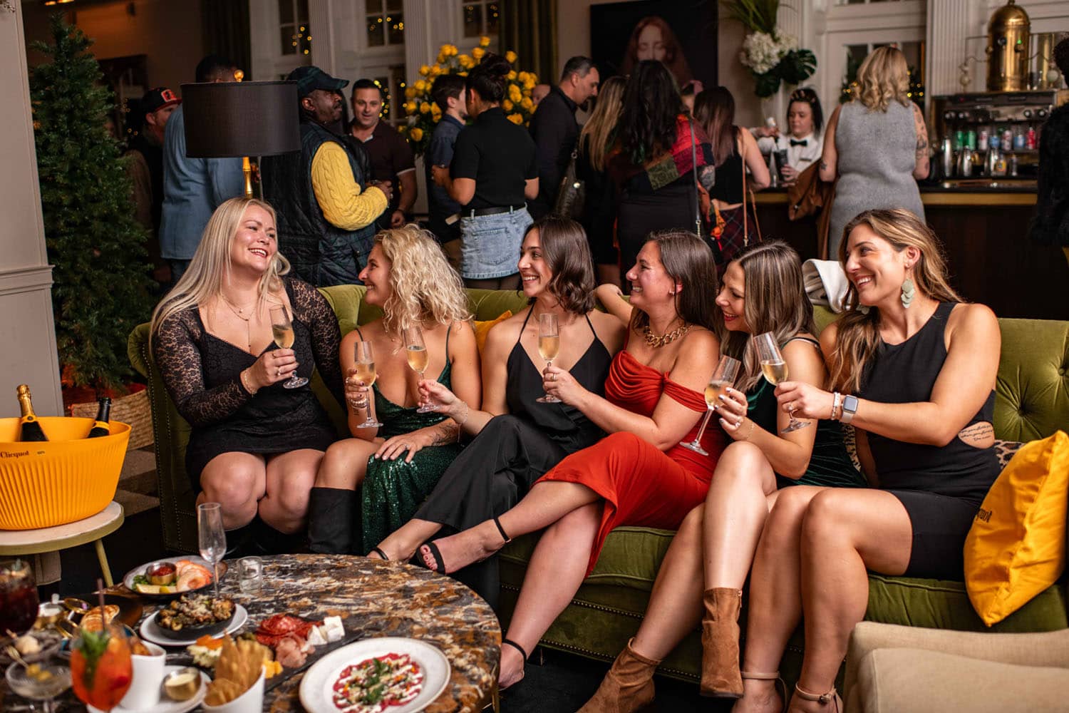 A group of women enjoying Bubbles Night inside The Raleigh Room