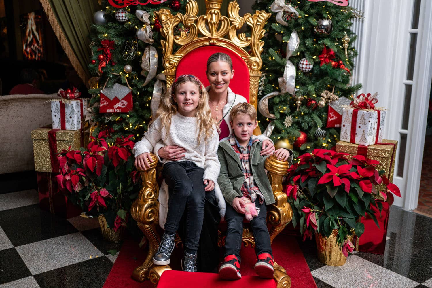 A family posing for a holiday photo inside The Historic Cavalier Hotel