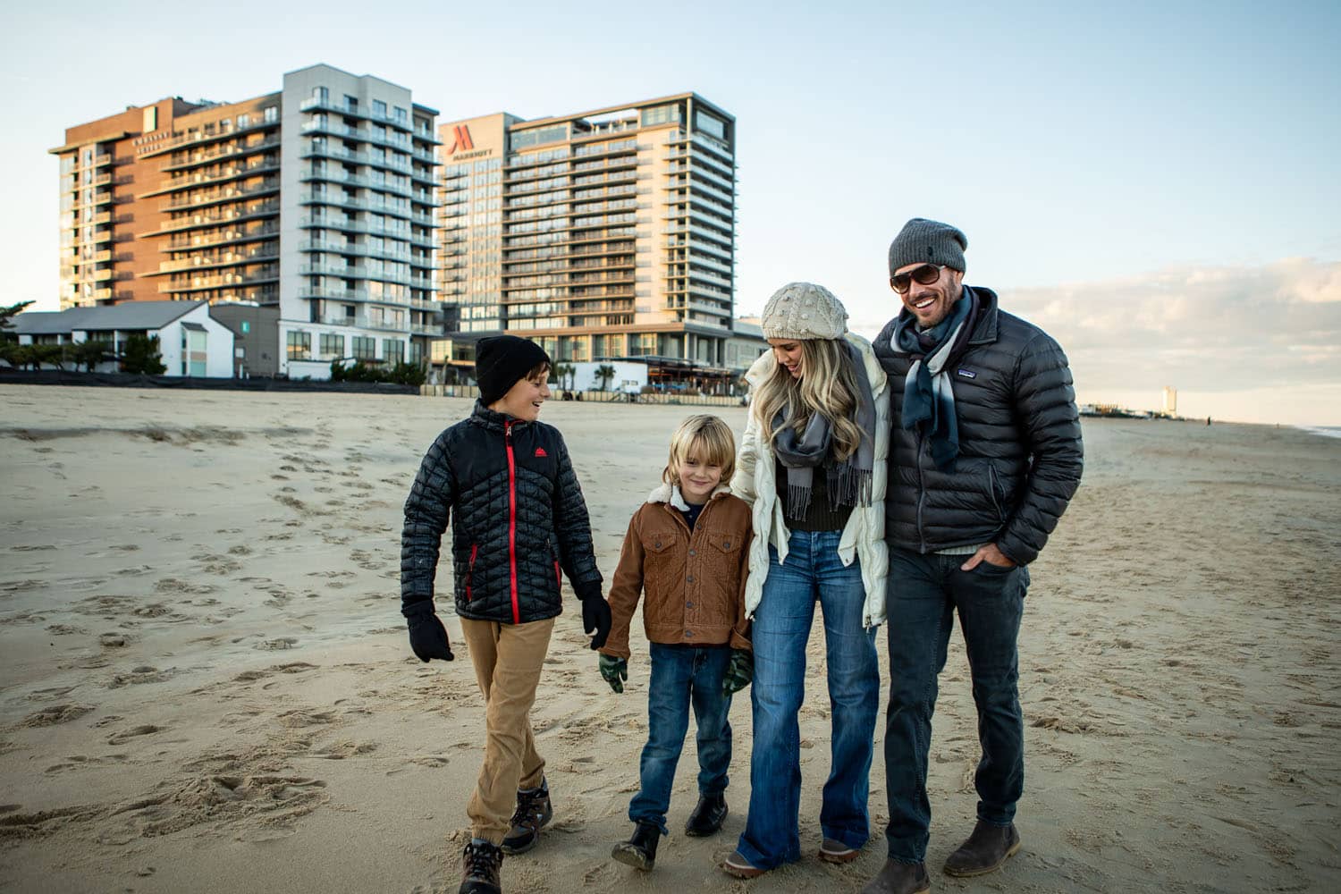 A family walking on the beach during winter