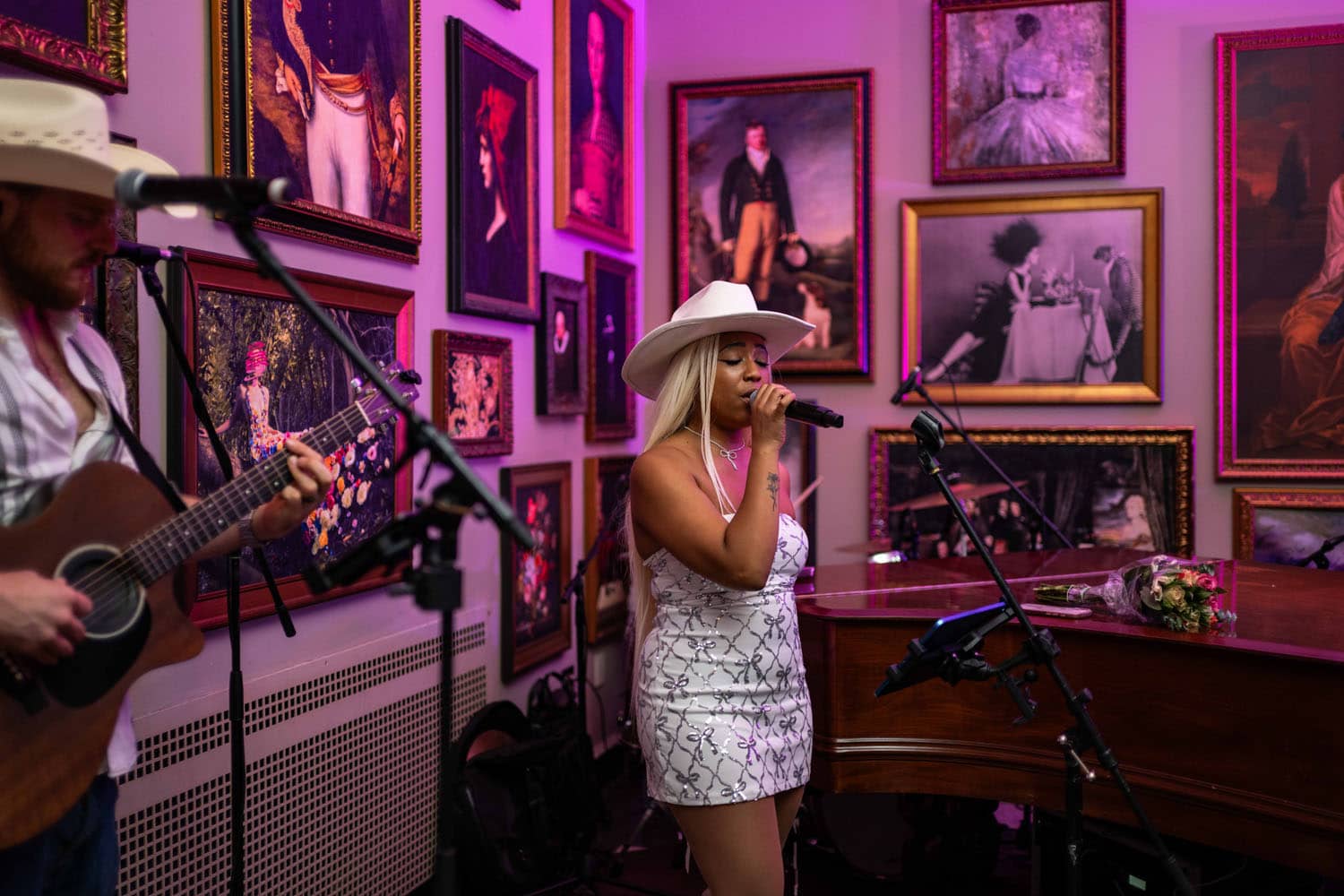 An artist performing live music inside The Raleigh Room