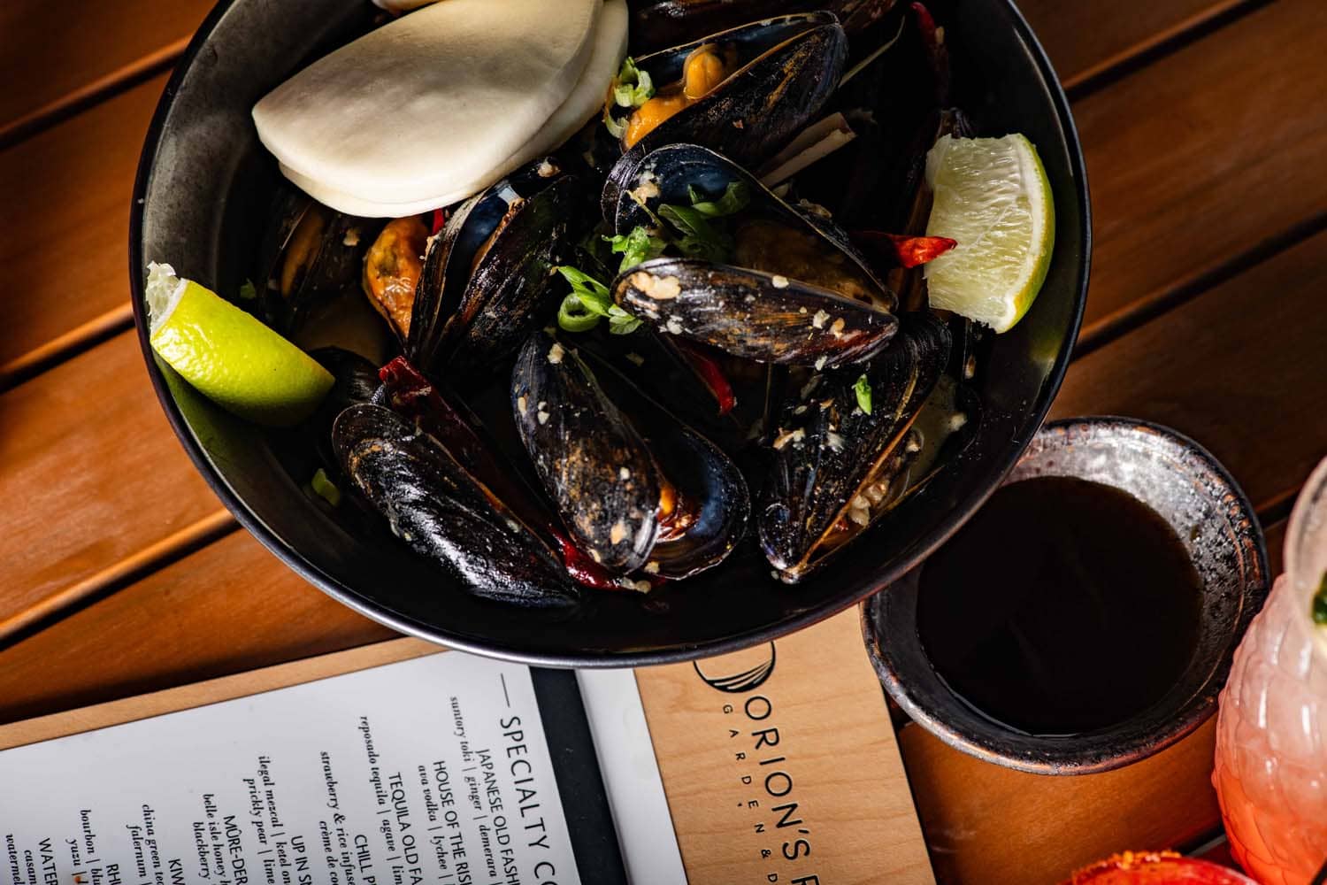 A close-up dish featuring steamed mussels in a bowl at Orion's Roof restaurant