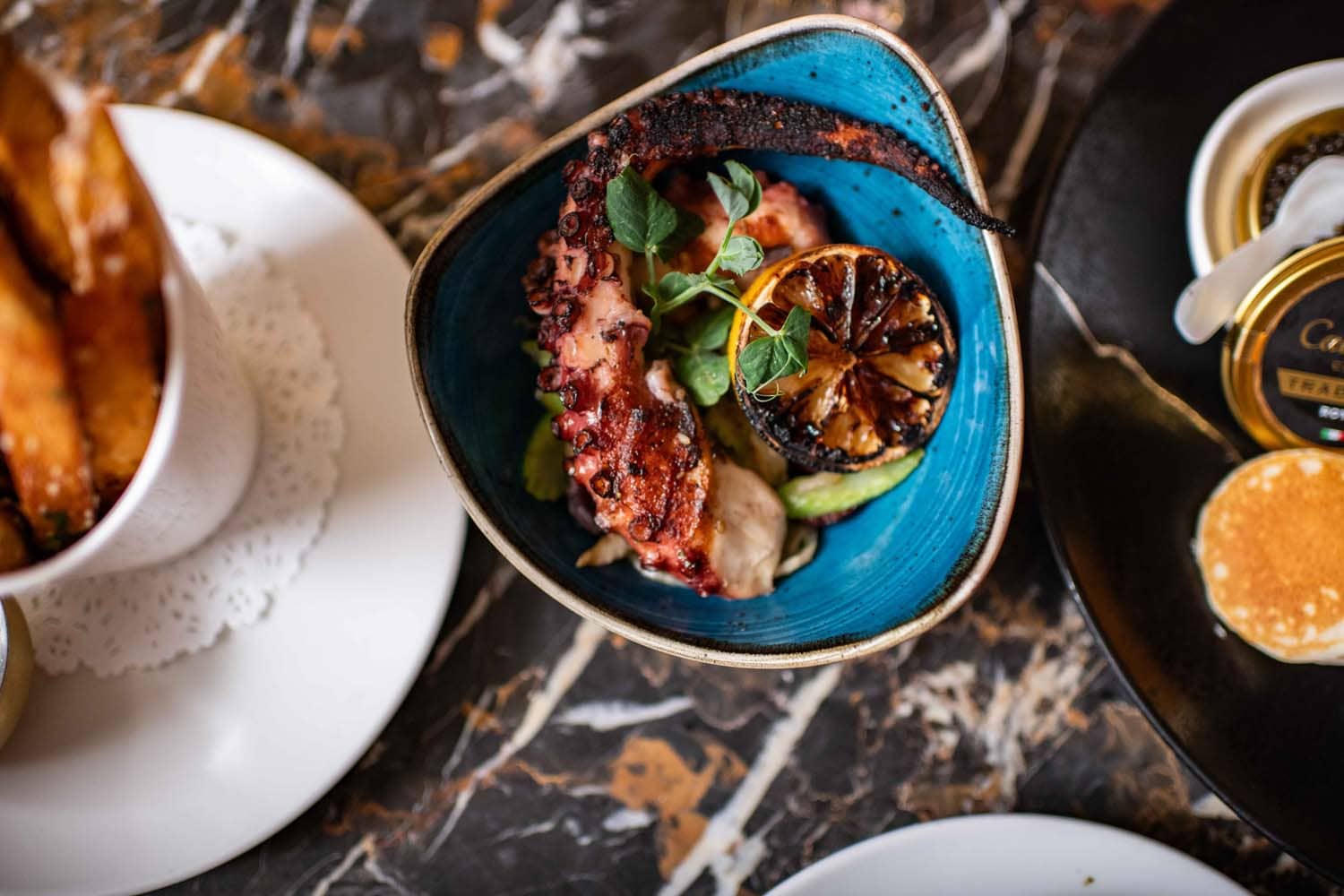A plated seafood dish on a table inside The Raleigh Room
