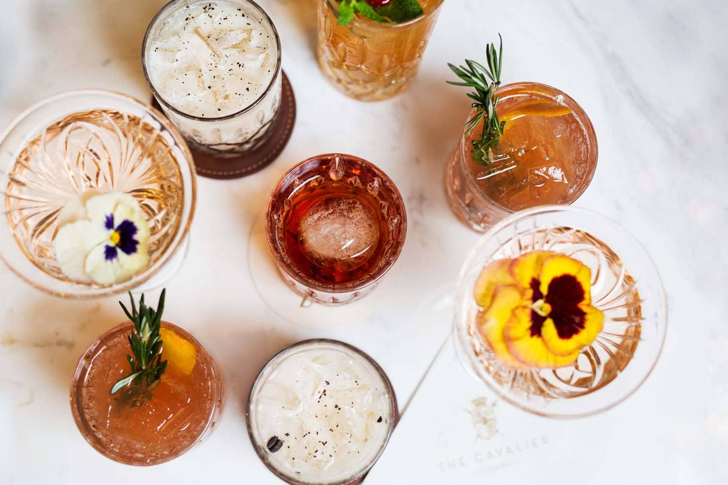 A close-up view of cocktails on a bar inside The Raleigh Room
