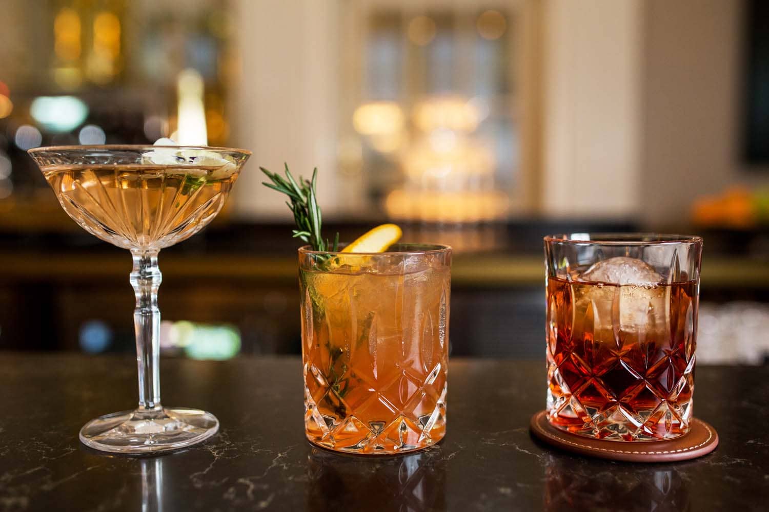 A close-up view of cocktails on a bar inside The Raleigh Room
