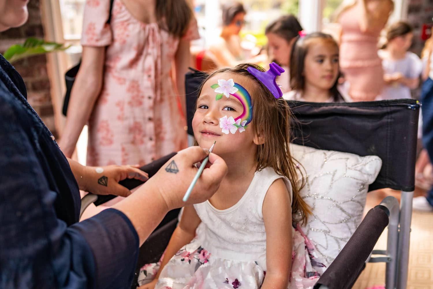 A child getting her face painted at an Easter event