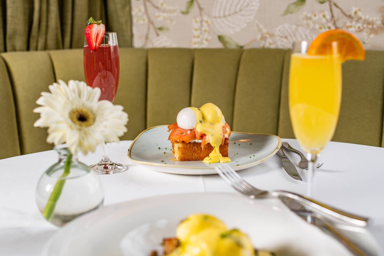 A brunch dish with drinks on a table at Becca Restaurant & Garden