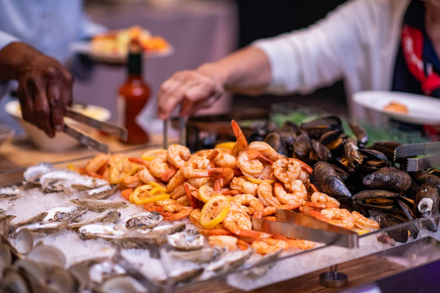 A close-up of oysters and shrimp on a table inside the Cavalier Crystal Ballroom