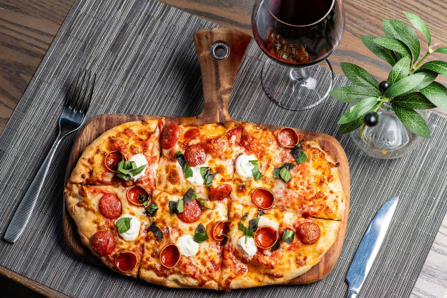 Pepperoni flatbread with fresh basil and ricotta served with red wine at Tulu Seaside Bar & Grill
