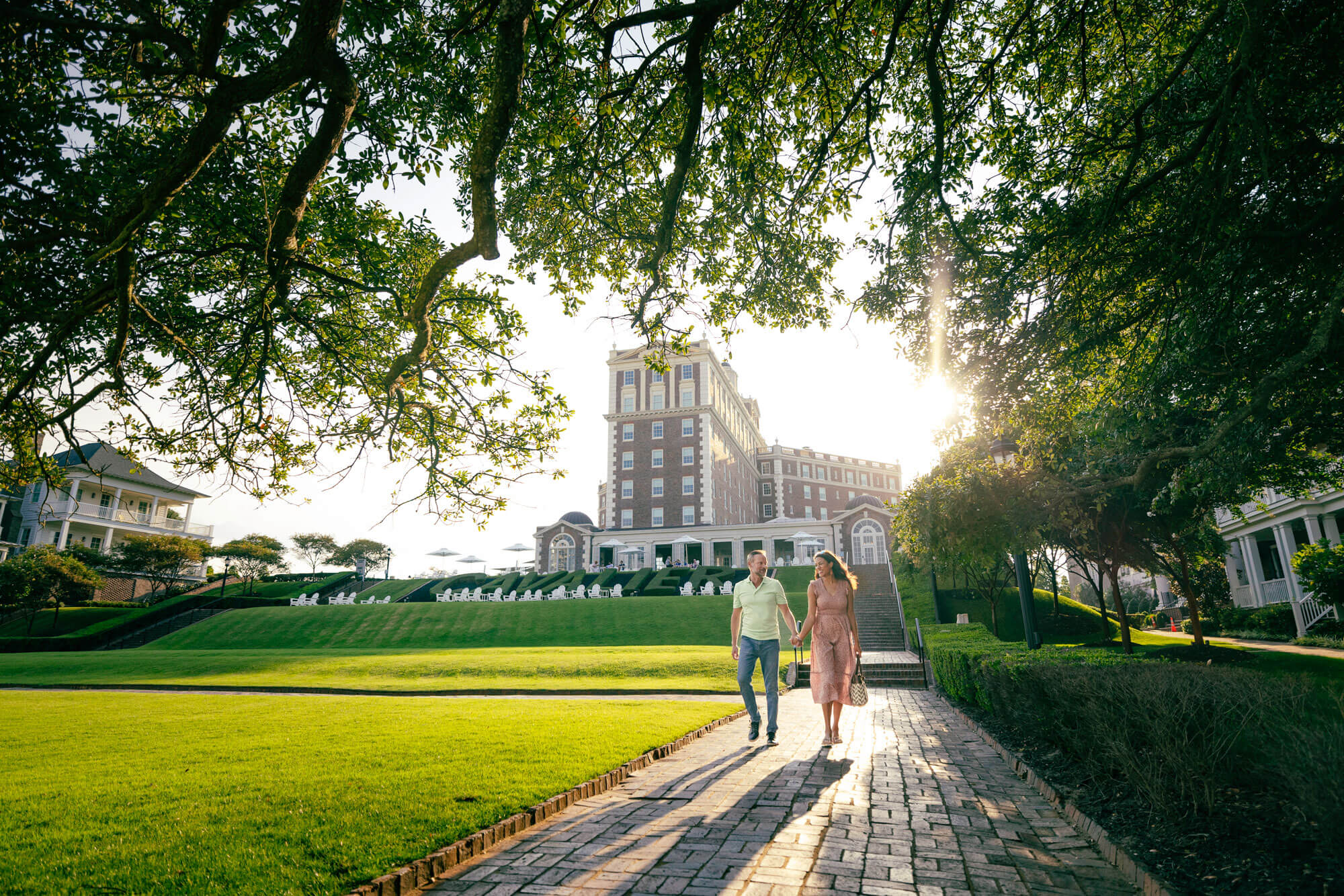 Couple walking on the paver pathway outside of The Historic Cavalier Hotel